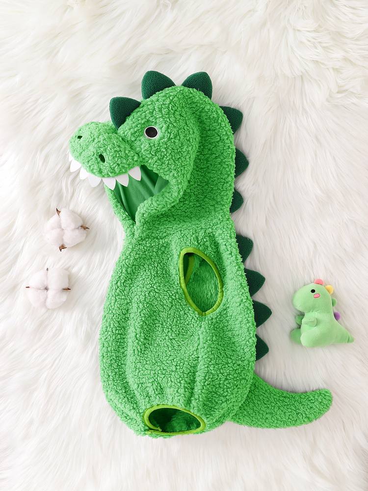 Green dinosaur romper from the side, showing the felt teeth, the spikes down the back and the tail